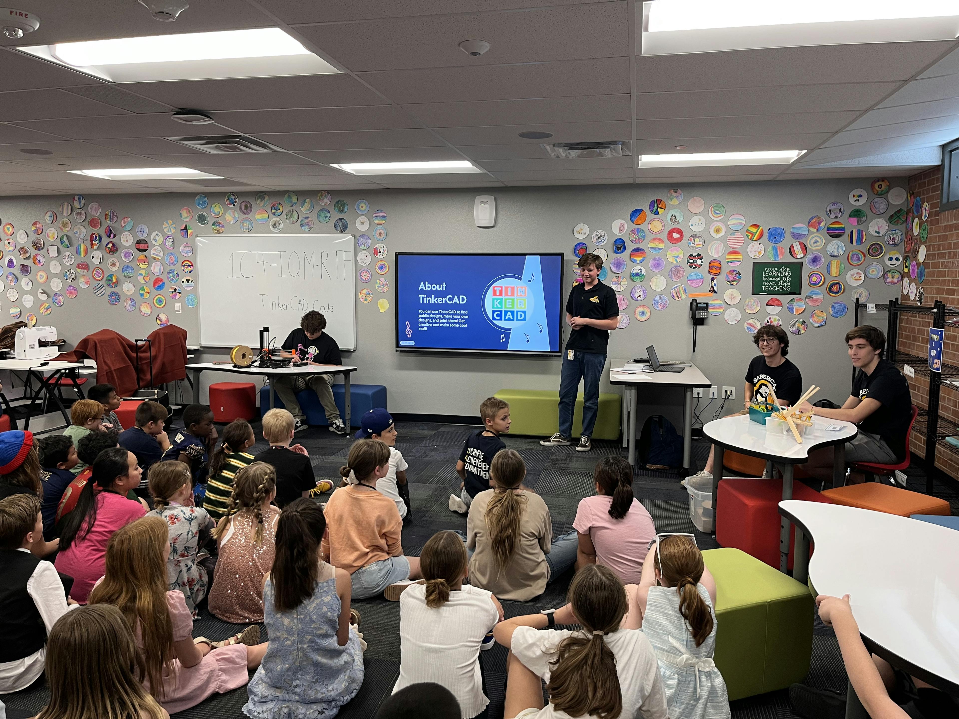 Melody Makers volunteers presenting to elementary school students how to use TinkerCAD, an online 3D printing program.